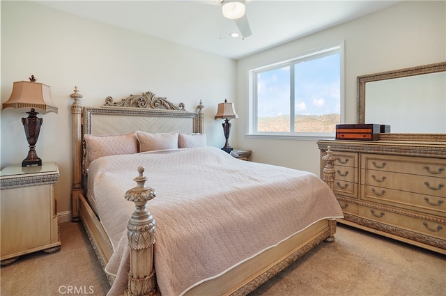 bedroom with ceiling fan and light colored carpet