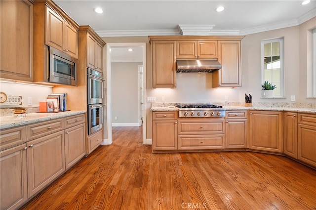 kitchen featuring light hardwood / wood-style flooring, stainless steel appliances, and crown molding