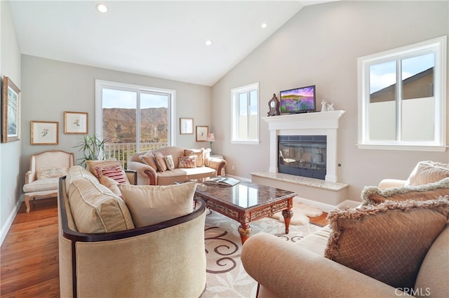 living room with lofted ceiling and light hardwood / wood-style flooring