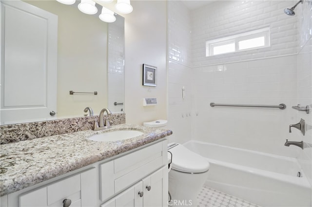 full bathroom featuring vanity, tiled shower / bath combo, and toilet