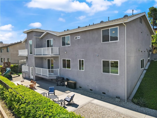 back of house featuring a patio and a balcony