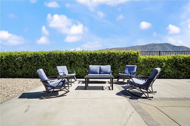 view of patio featuring an outdoor living space and a mountain view