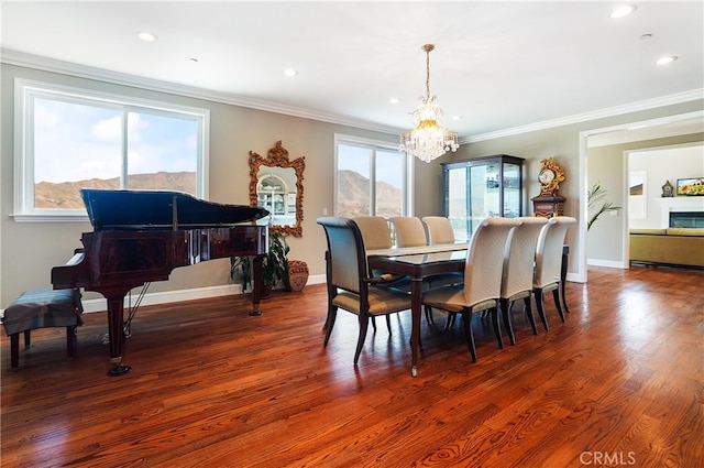 dining area with a healthy amount of sunlight, ornamental molding, and dark hardwood / wood-style floors