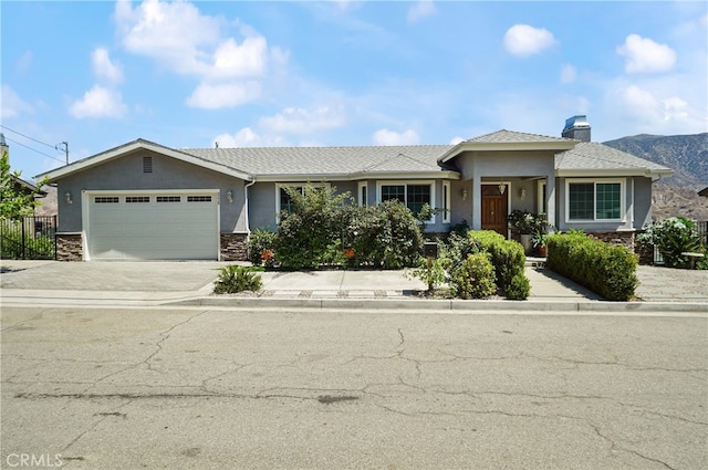 view of front of property featuring a mountain view and a garage