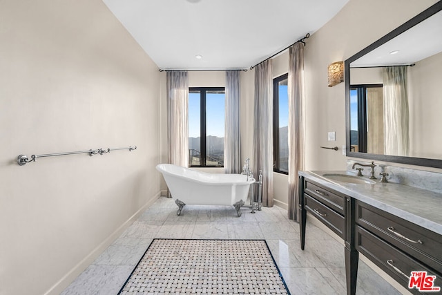 bathroom featuring vanity and a tub