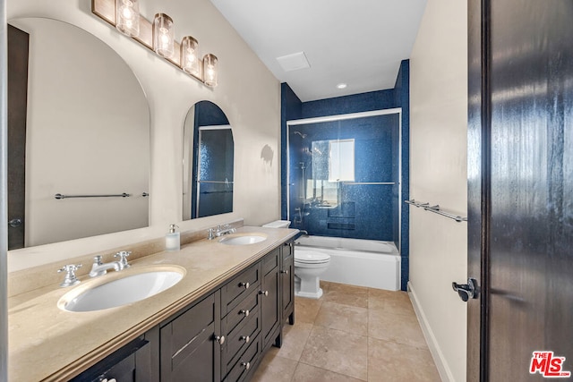 full bathroom featuring enclosed tub / shower combo, vanity, tile patterned flooring, and toilet