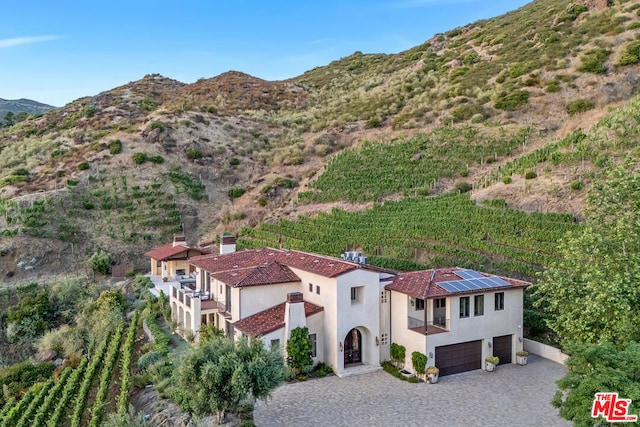 birds eye view of property with a mountain view and a rural view