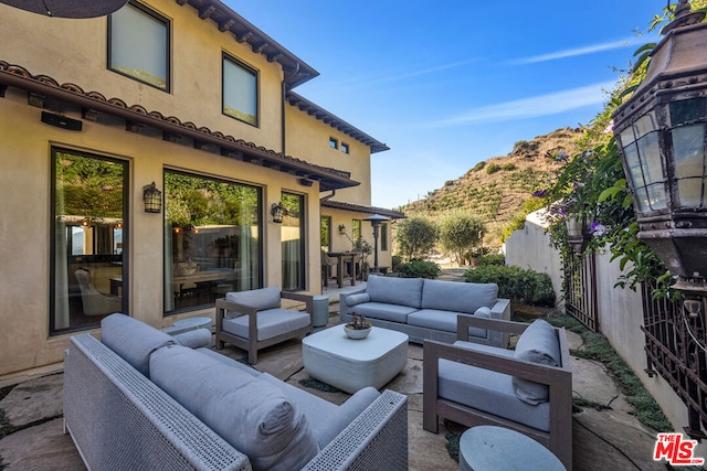 view of patio with outdoor lounge area and a mountain view