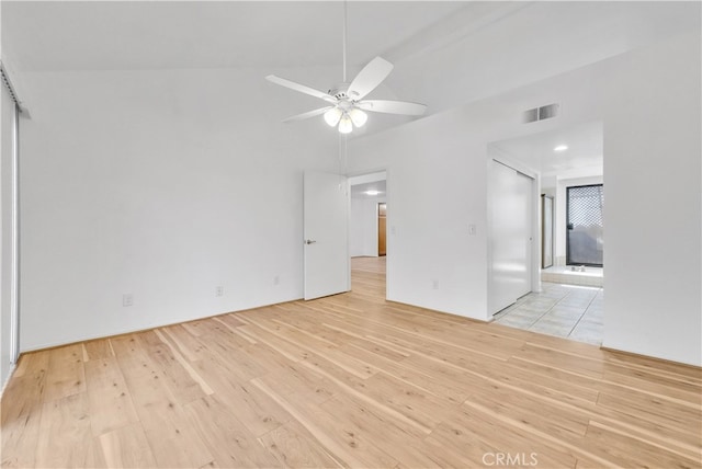 unfurnished living room featuring light wood-type flooring, lofted ceiling, and ceiling fan