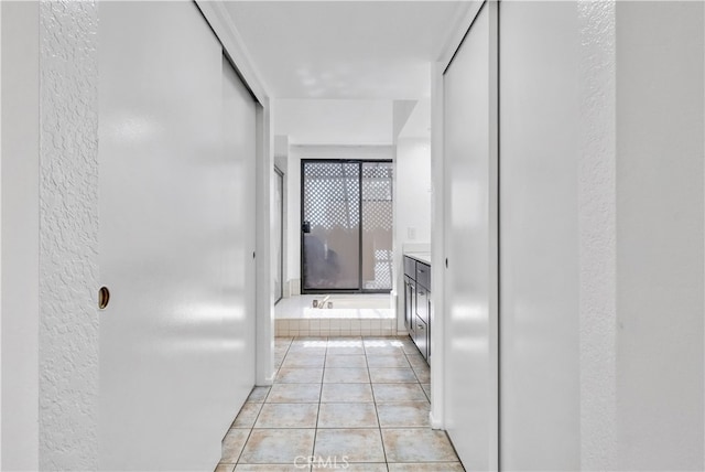 hall with light tile patterned floors