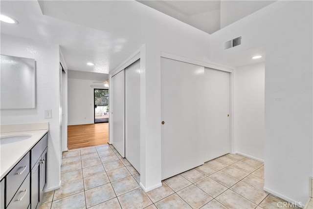 interior space featuring light tile patterned flooring and sink