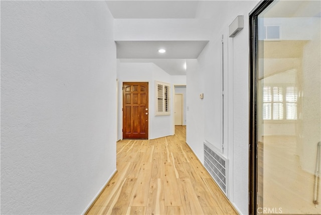 hallway with light hardwood / wood-style flooring