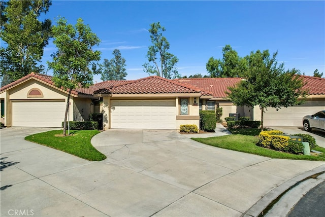 view of front facade with a garage and a front lawn