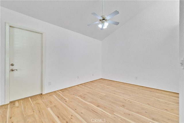 empty room with lofted ceiling, ceiling fan, and hardwood / wood-style flooring