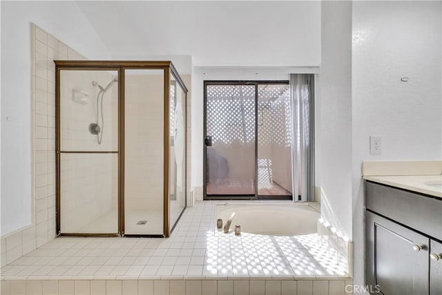 bathroom featuring vanity and separate shower and tub