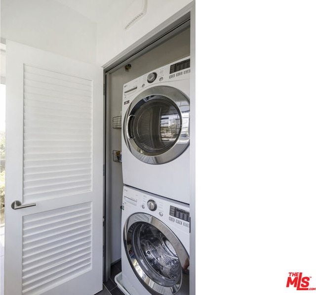 washroom with stacked washing maching and dryer