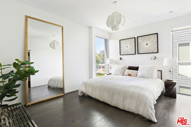 bedroom with dark wood-type flooring