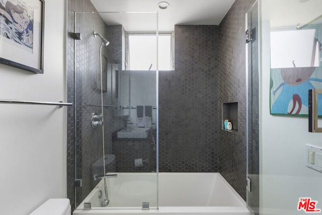 bathroom featuring toilet and enclosed tub / shower combo