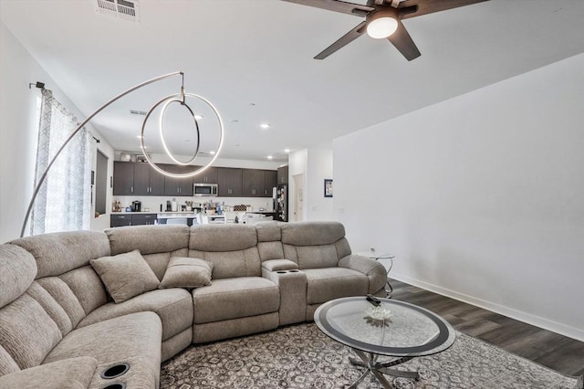 living room featuring ceiling fan and wood-type flooring