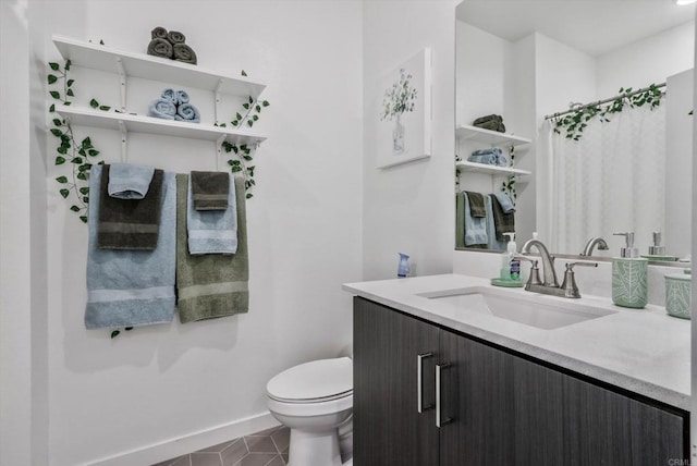 bathroom featuring toilet, vanity, and tile patterned floors