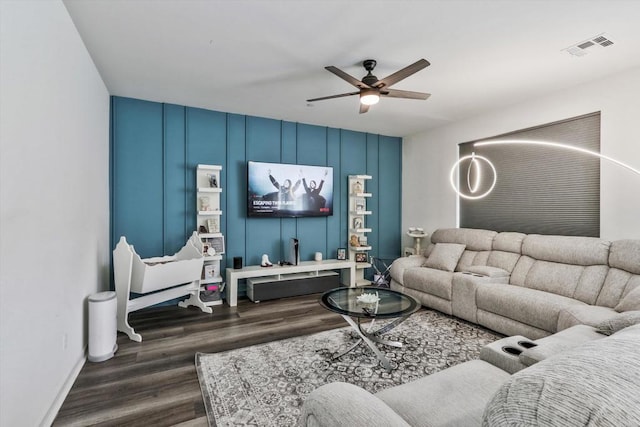 living room featuring dark hardwood / wood-style floors and ceiling fan