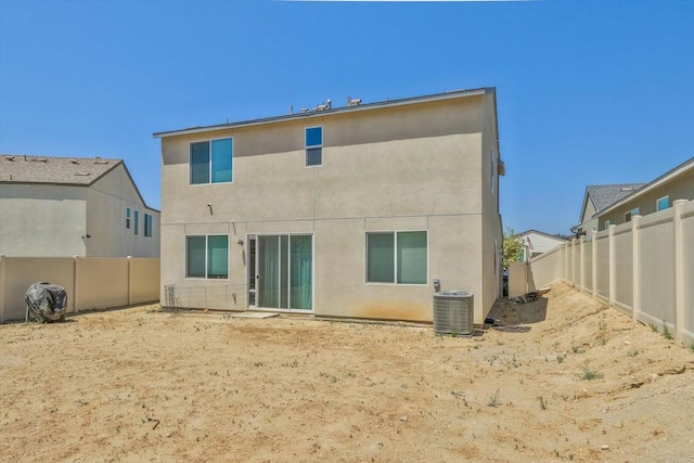 rear view of house with central AC