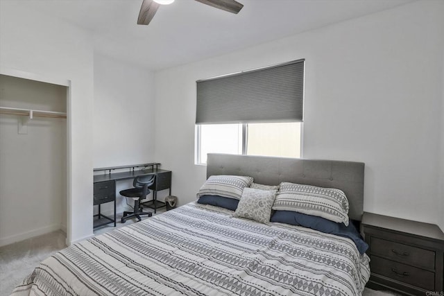 carpeted bedroom with ceiling fan and a closet