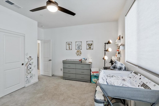 bedroom with ceiling fan and light colored carpet