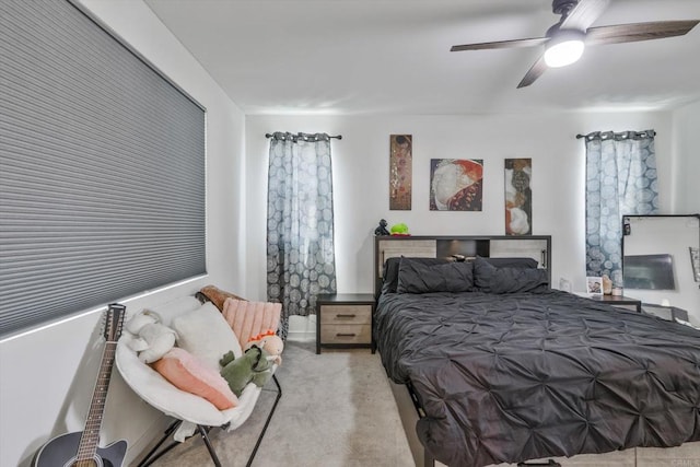 bedroom with ceiling fan and light colored carpet