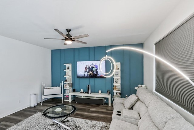 living room with dark hardwood / wood-style floors and ceiling fan