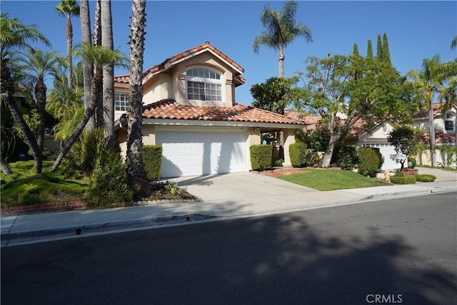 mediterranean / spanish house featuring a garage