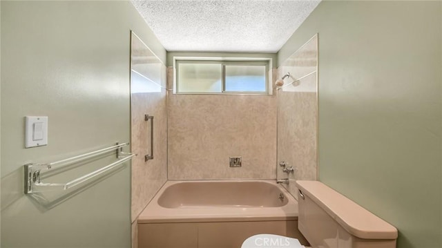 bathroom with tiled shower / bath combo, toilet, and a textured ceiling