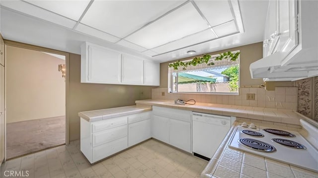 kitchen featuring backsplash, tile counters, white cabinets, and white appliances