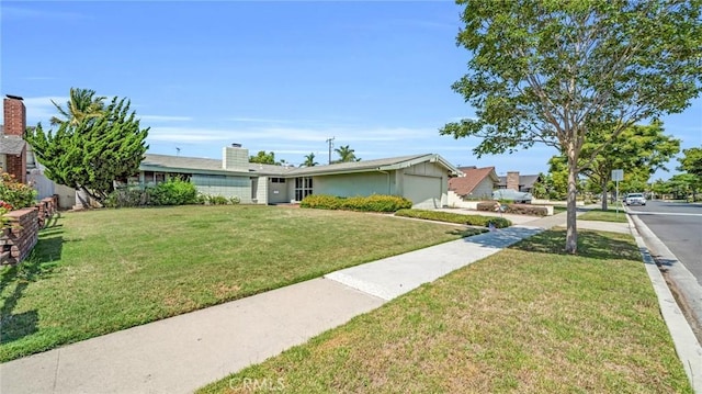 view of front of home featuring a garage and a front lawn