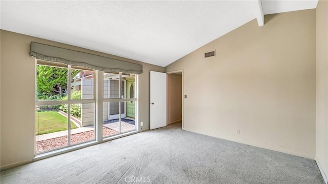 carpeted empty room with plenty of natural light, beamed ceiling, and high vaulted ceiling