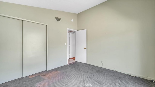 unfurnished bedroom featuring carpet flooring and a closet