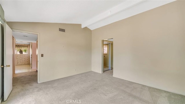 unfurnished room featuring light carpet and lofted ceiling with beams