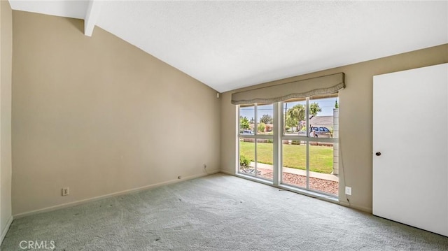 carpeted empty room featuring vaulted ceiling with beams and a healthy amount of sunlight