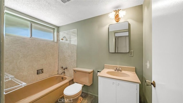 full bathroom with a textured ceiling, vanity, toilet, and tiled shower / bath