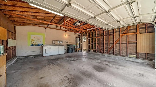 garage featuring water heater and a garage door opener