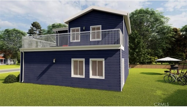 rear view of property with a lawn and a balcony