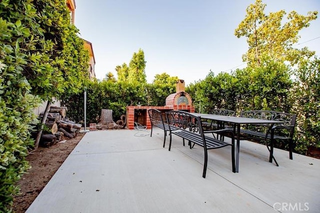 view of patio / terrace with exterior fireplace