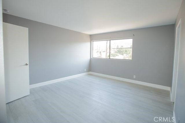 spare room featuring light hardwood / wood-style flooring