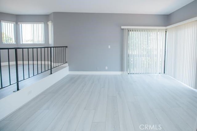 spare room featuring light hardwood / wood-style flooring