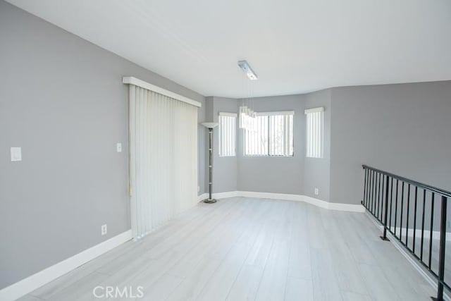 unfurnished room with light hardwood / wood-style floors