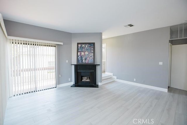 unfurnished living room with light hardwood / wood-style flooring