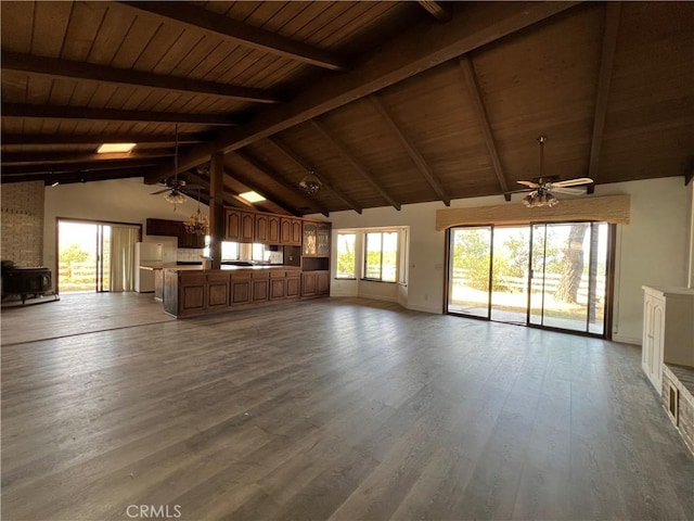 unfurnished living room with beam ceiling, hardwood / wood-style floors, high vaulted ceiling, and wood ceiling