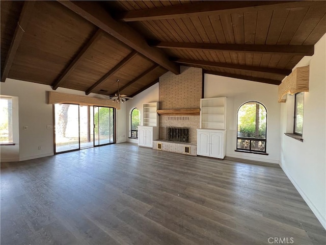 unfurnished living room featuring a healthy amount of sunlight and dark wood-type flooring