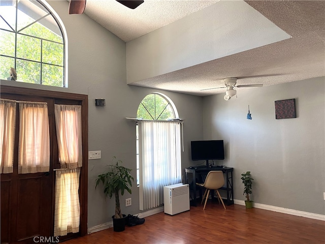 home office featuring ceiling fan, a textured ceiling, and dark hardwood / wood-style flooring