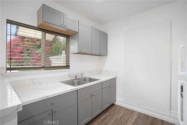 kitchen featuring dark hardwood / wood-style flooring, sink, and gray cabinetry